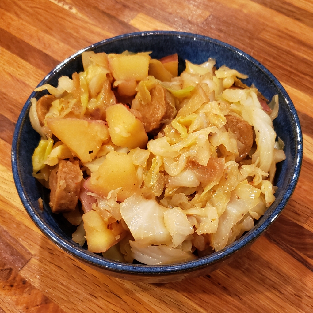 A dishful of cabbage, potato and plant-based Kielbasa.